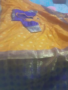 mango colour saree with ready stitched pattern blouse....