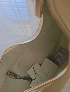CHARLES &amp; KEITH Cream Philomena Half-Moon Bag