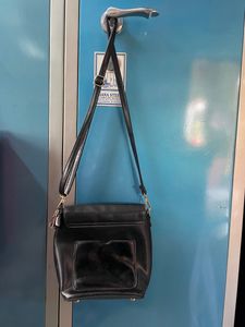 Black Sling Bag From Ajio. This Sling Is Sturdy and Useful For Keeping A Small Purse Along With Two Phones And Other Small Items. Bag Has 5 Compartments.