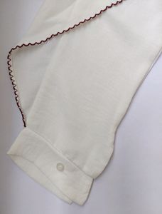 White shirt with red scallop detailing