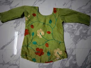 Green Embroidered short kurta top.