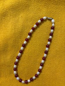 it’s a chain . it’s white and maroon mixed col