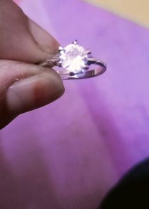 beautifull silver color ring, adjustable with intact stone..