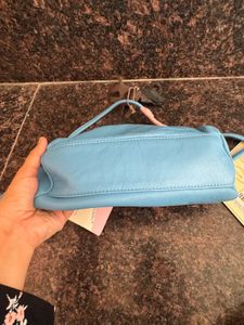 Hidesign sling with leather charm n dust bag
