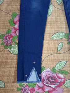 Dark Blue Jeans With Cut On Left Leg..