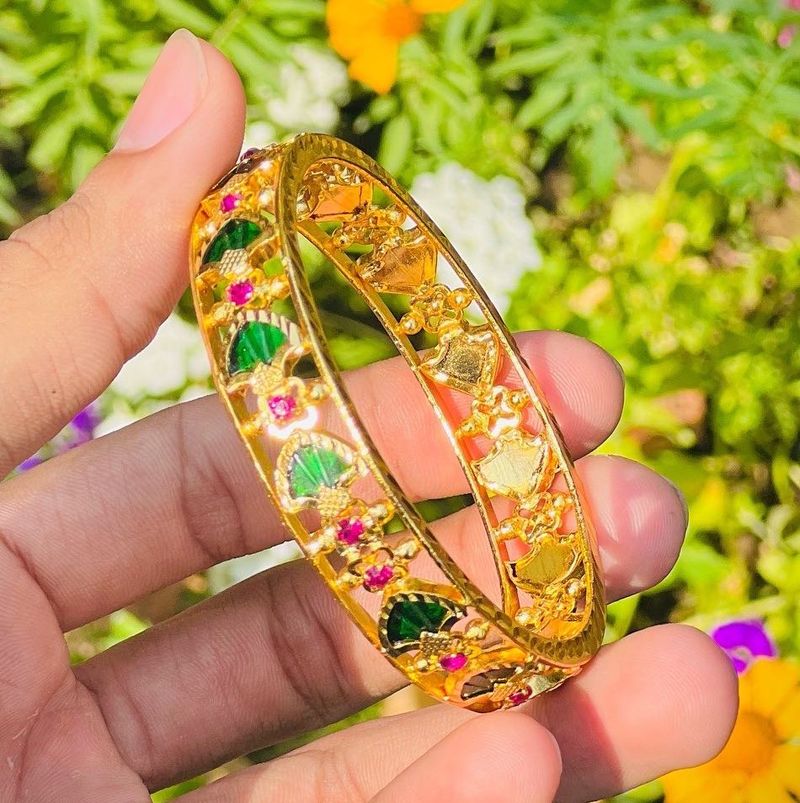 Elegant Gold Bangle with Green and Pink Stones
