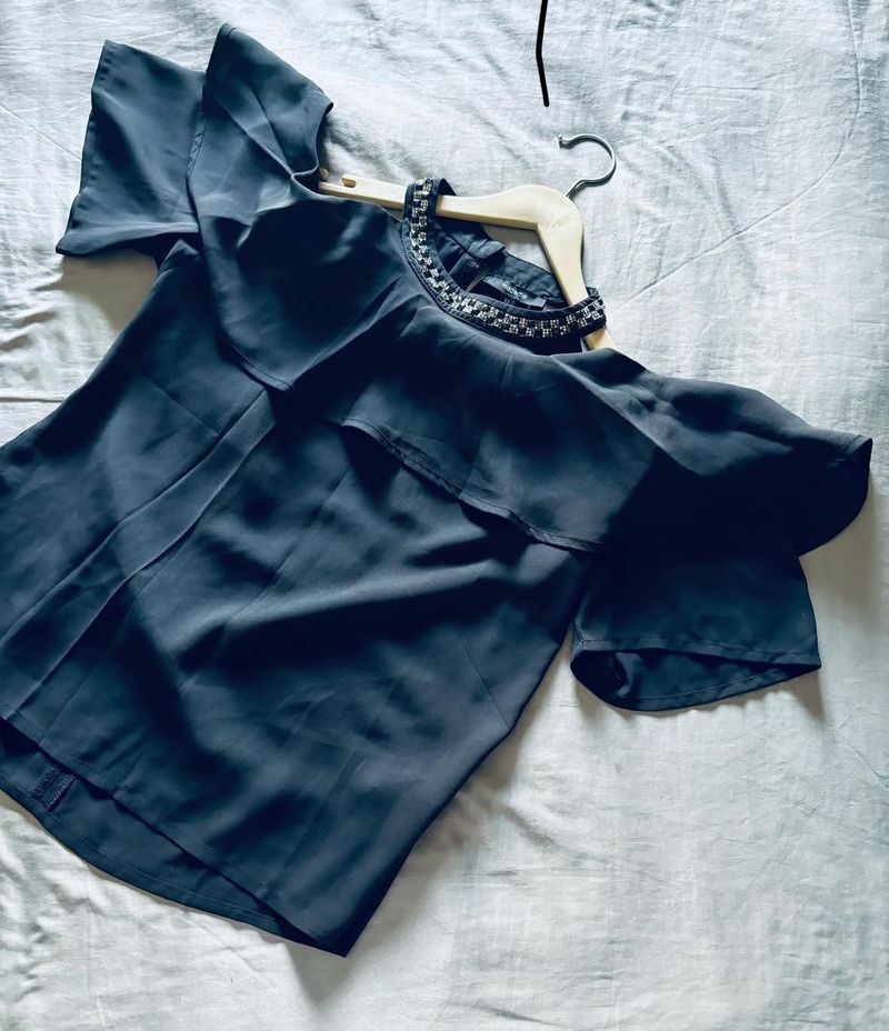 women’s black blouse featuring short sleeves, a so