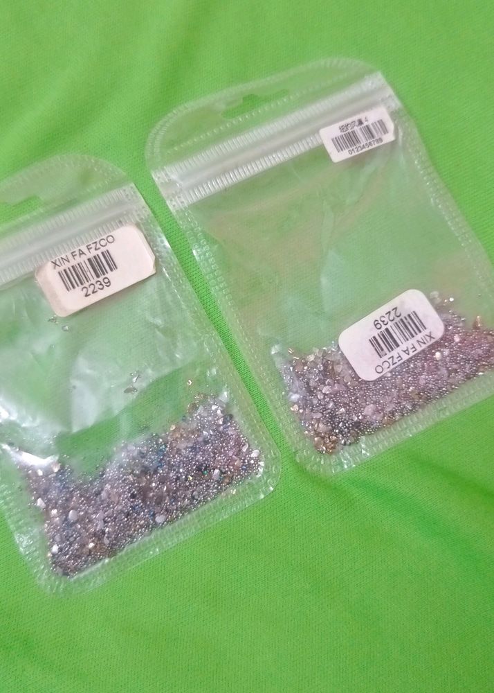 Nail art, glitter and crystals.