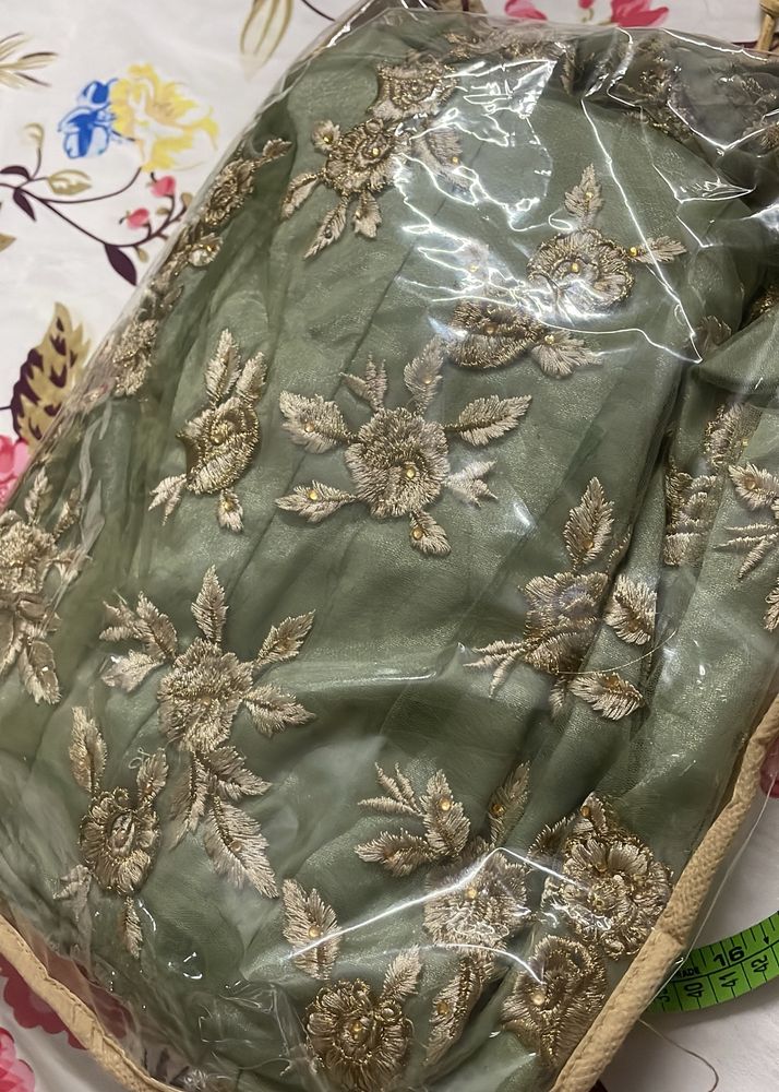 A Heavily Embroidered Pista Green Ethnic Gown