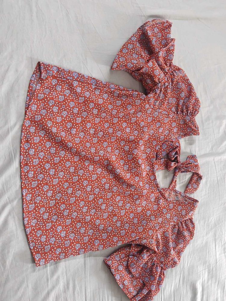 Red top with floral blue pattern