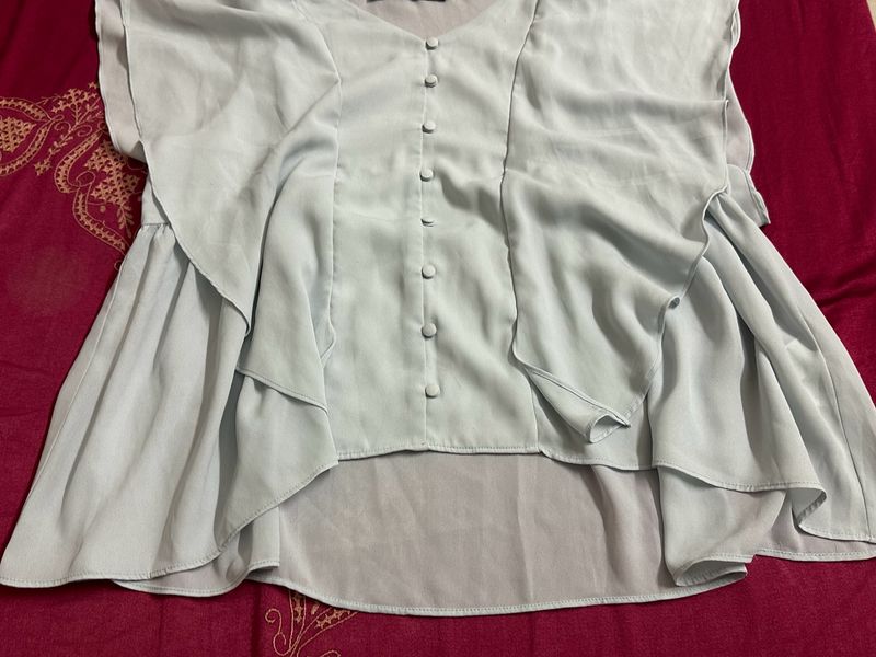 light blue frilled top