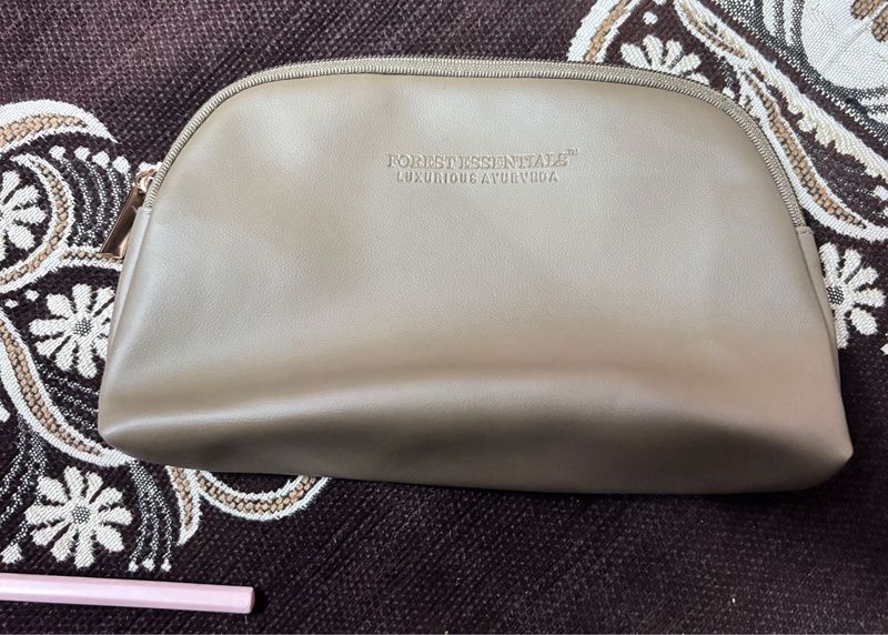 This is a taupe faux leather makeup bag