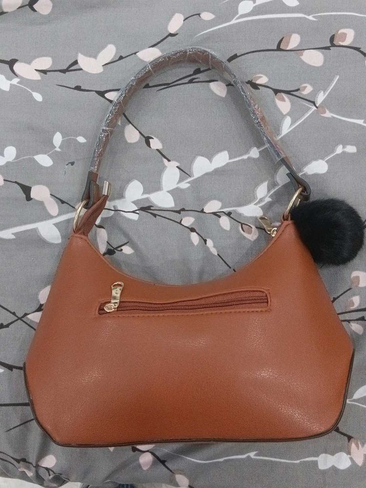 Chic Brown Handbag with Pom-Pom Charm