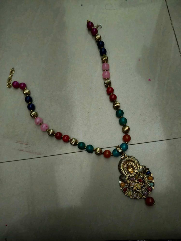 Beaded necklace with golden pendant