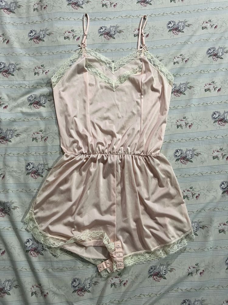 Vintage-Inspired Pink Satin Romper with Lace Trim