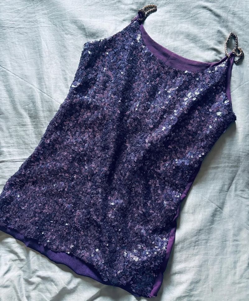 The fabric is covered with small, shiny sequins th