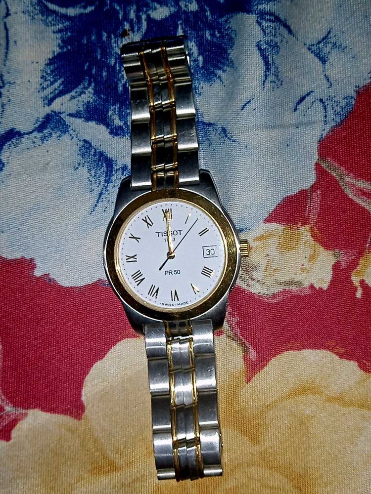 A gold and silver shining tissot watch