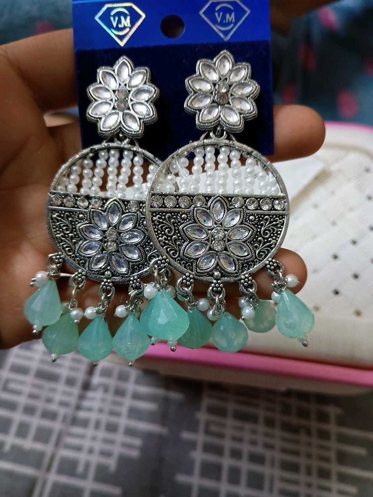 a pair of lightweight ethnic white earrings with
