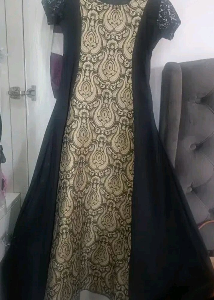 Black gown with cream colour combination. Ideal for parties marriage functions. Have net half sleeves .Stuff is good