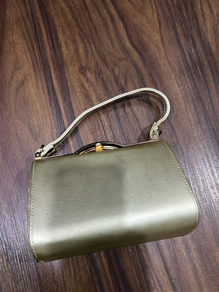 Gold Hand  Bag With Removable Sling And 2 Zip Pockets Inside. One In Center And One On Side