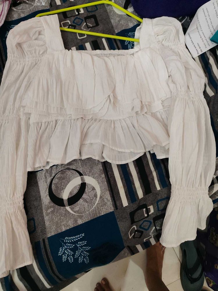 white bell bottom sleeves top.