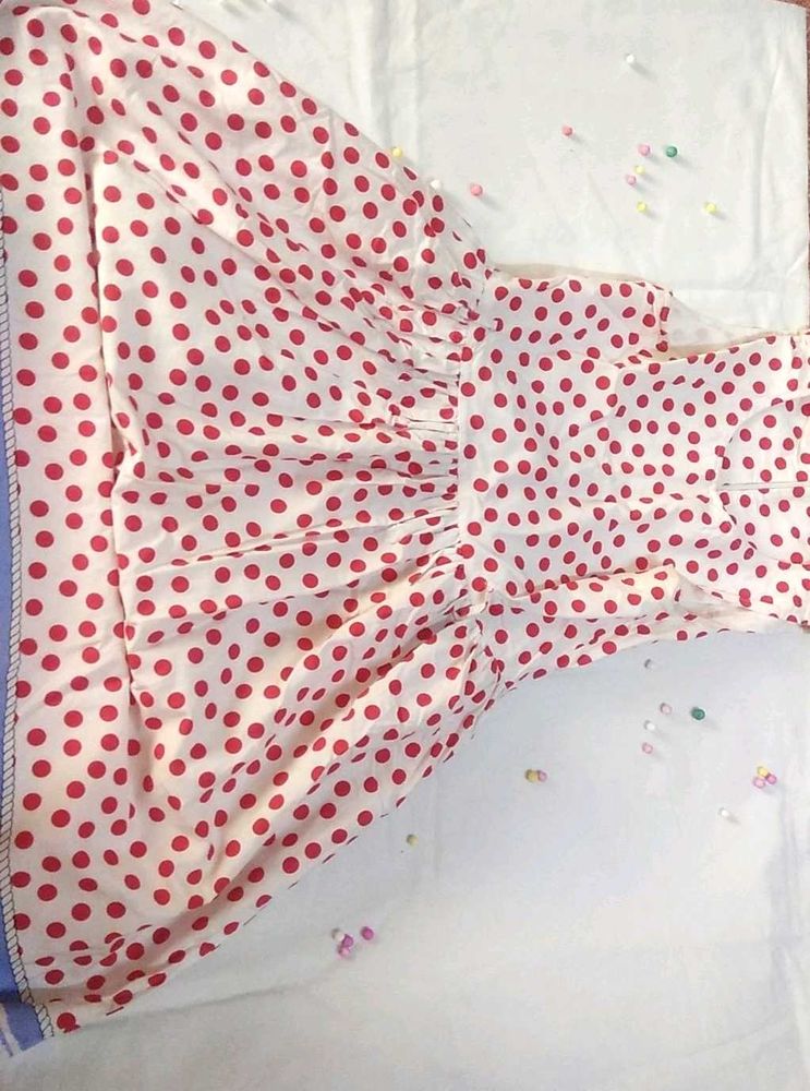 A Beautiful White Frok With Red Polka Dots