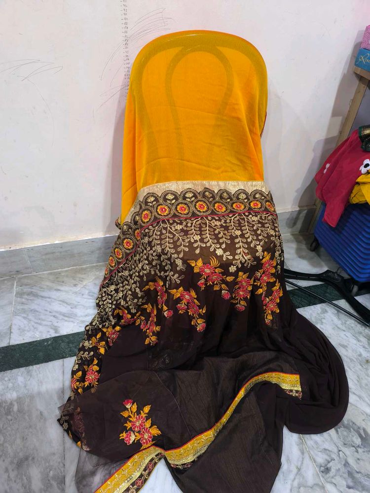 Yellow and brown new saree with intact blouse piec