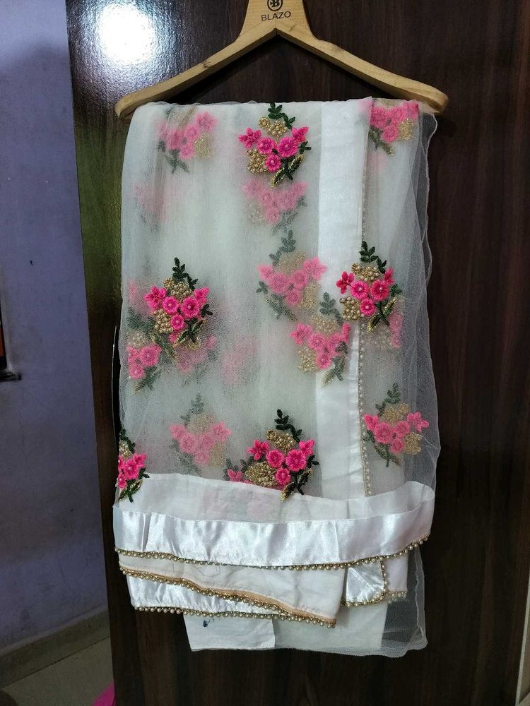 Embroidered netted saree with boat neck bl