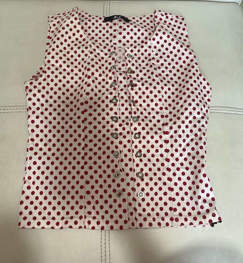 white top with red polka dots