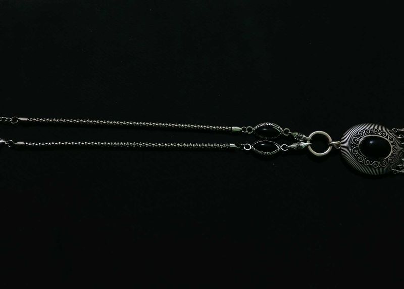 A Black Necklace along With White One