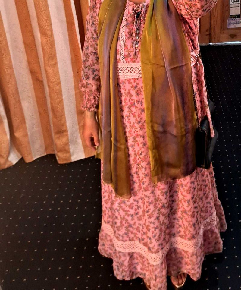 A pink floral gown with white lace trim
