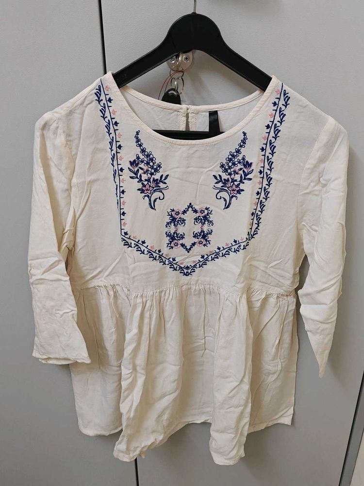 White Embroidered Peplum Top