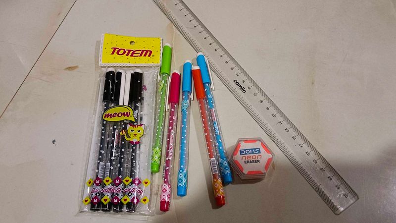 combo of pens scale and eraser