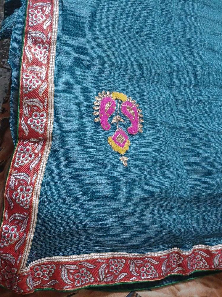 Embroidered super net saree with red border