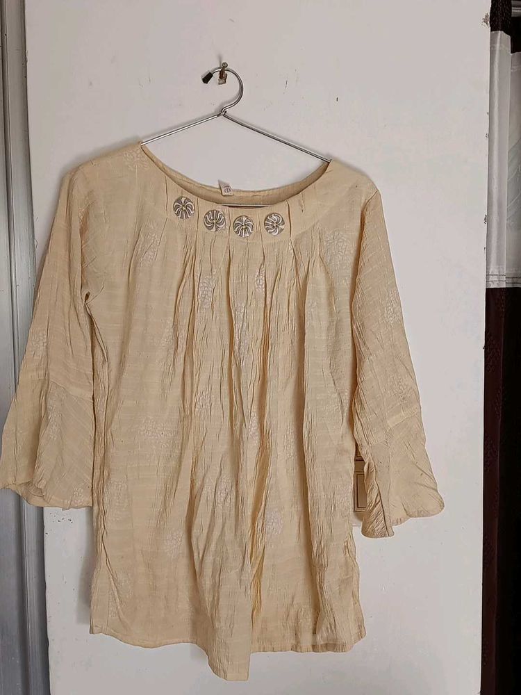 This is a Tunic Top With Button On It