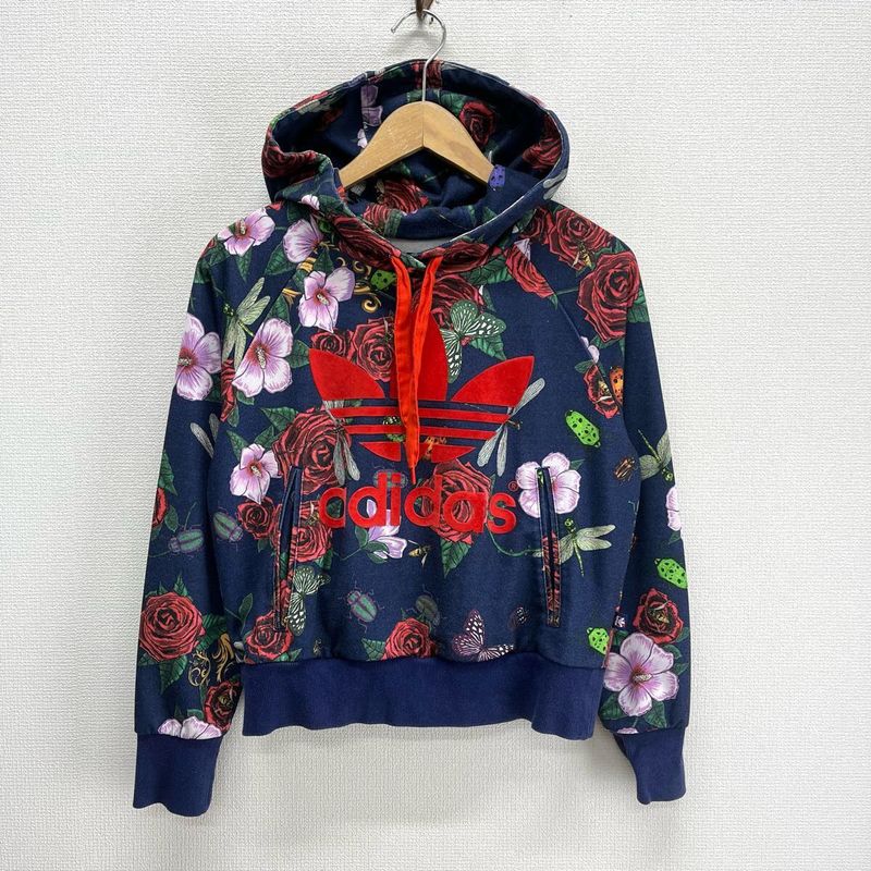 This is an Adidas x Rita Ora navy floral pullover