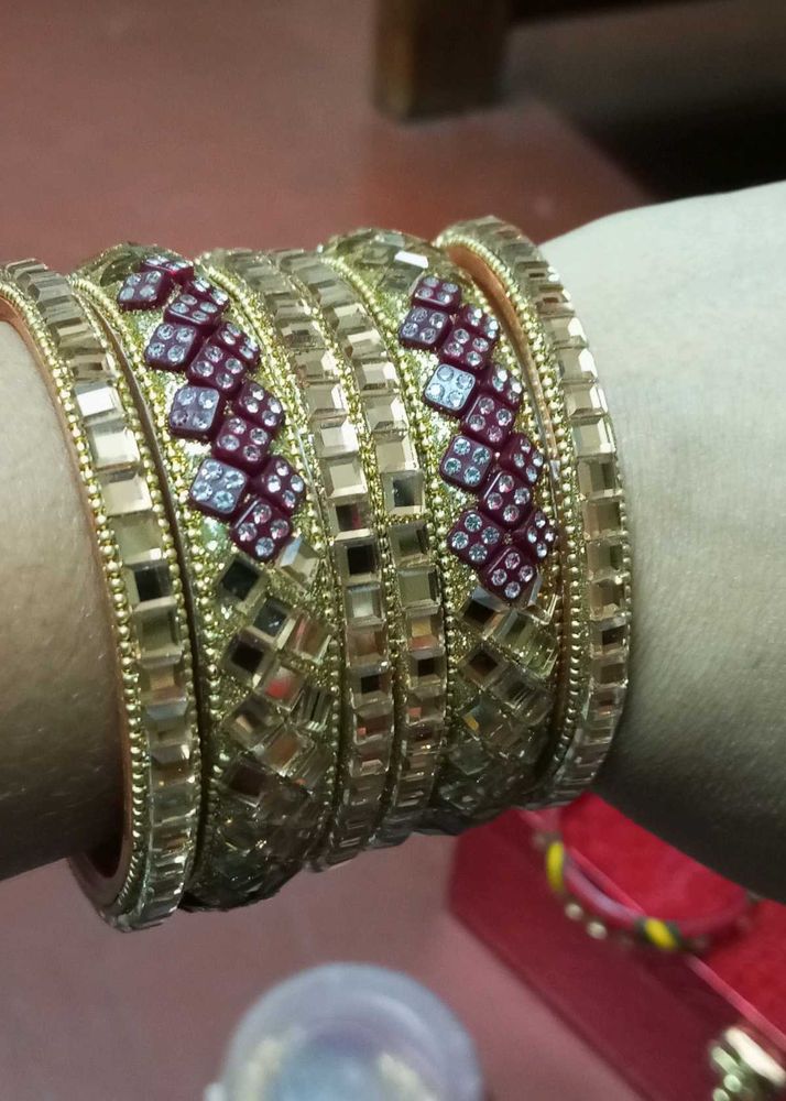 Set of Gold Bangles with Red Accents