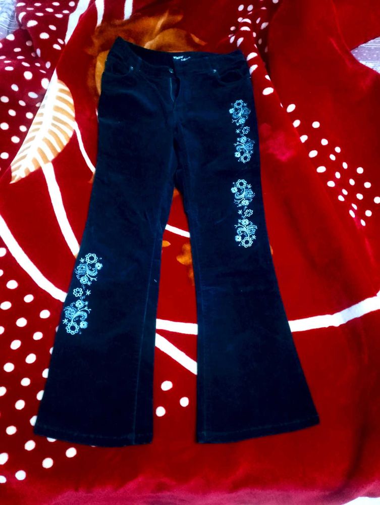 Black Coloured Bootcut Jean With Embroidery On It.