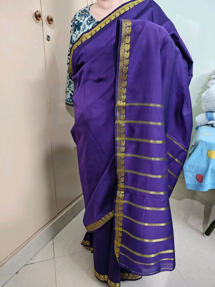 Purple coloured artificial silk saree with 1.5 inch ethnic design golden border