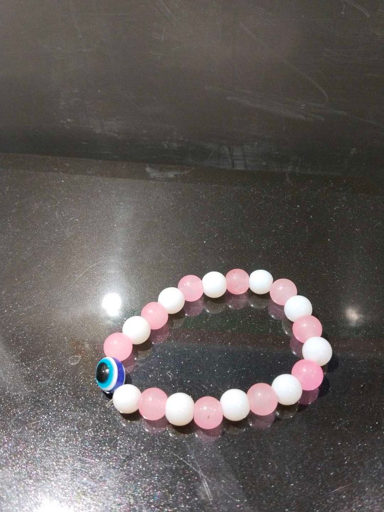 Pink And White Bracelet With An Evil Eye In It