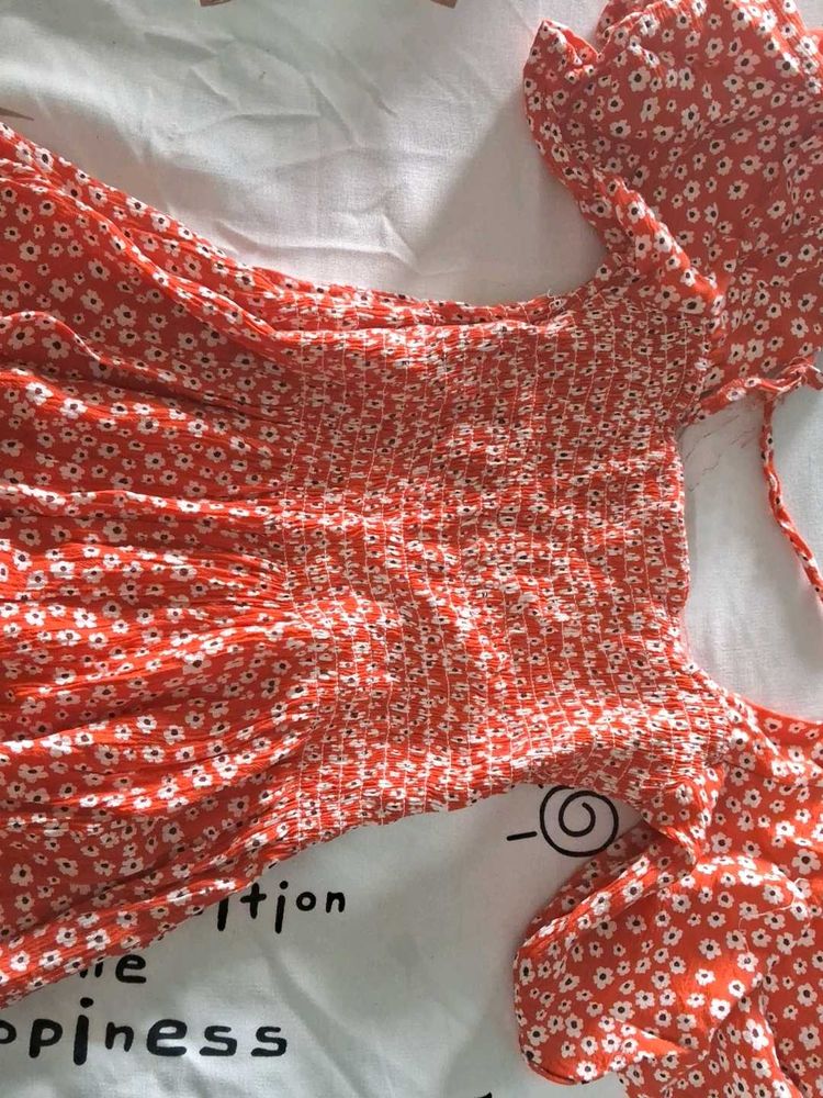 Orange Peplum Top With White Flowers