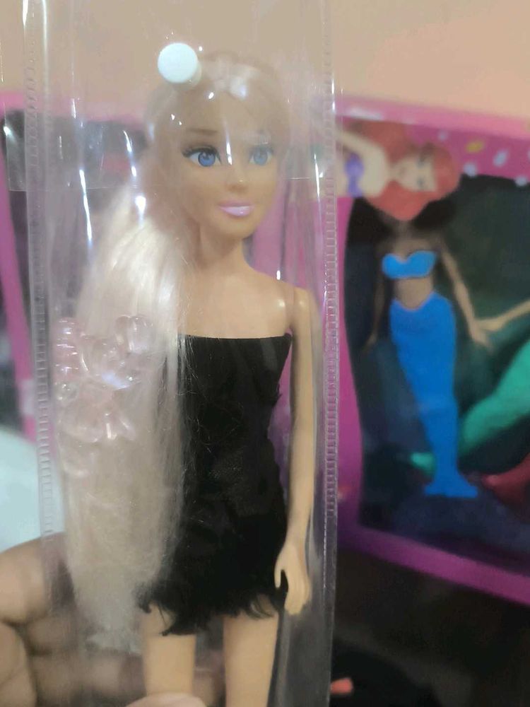 Hannah doll in black dress with long hair.