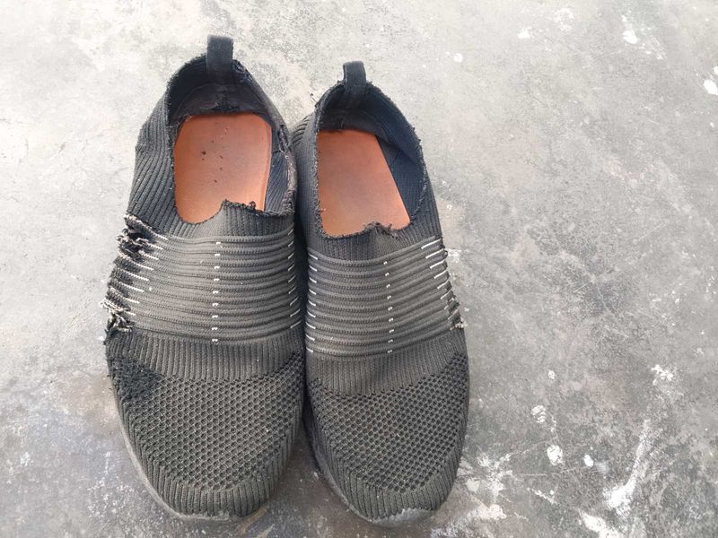 Worn Black Sneakers