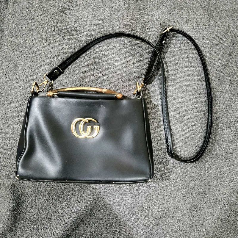Elegant Black Sling Handbag with Gold Detailing