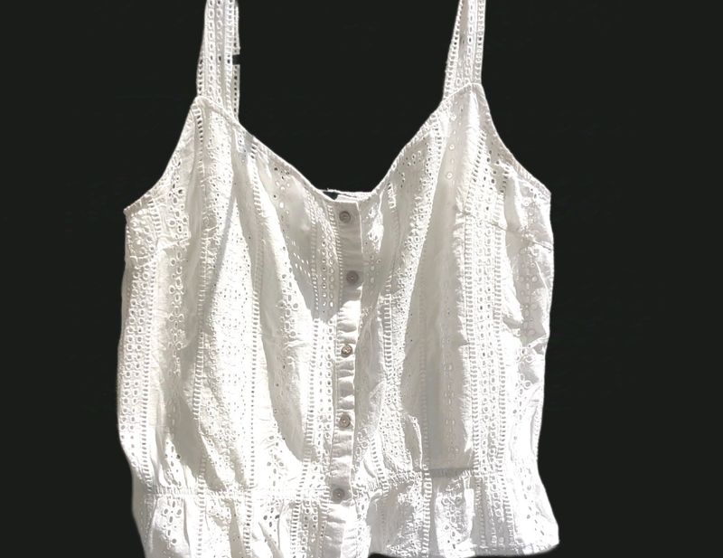 button-up tank top with spaghetti straps.