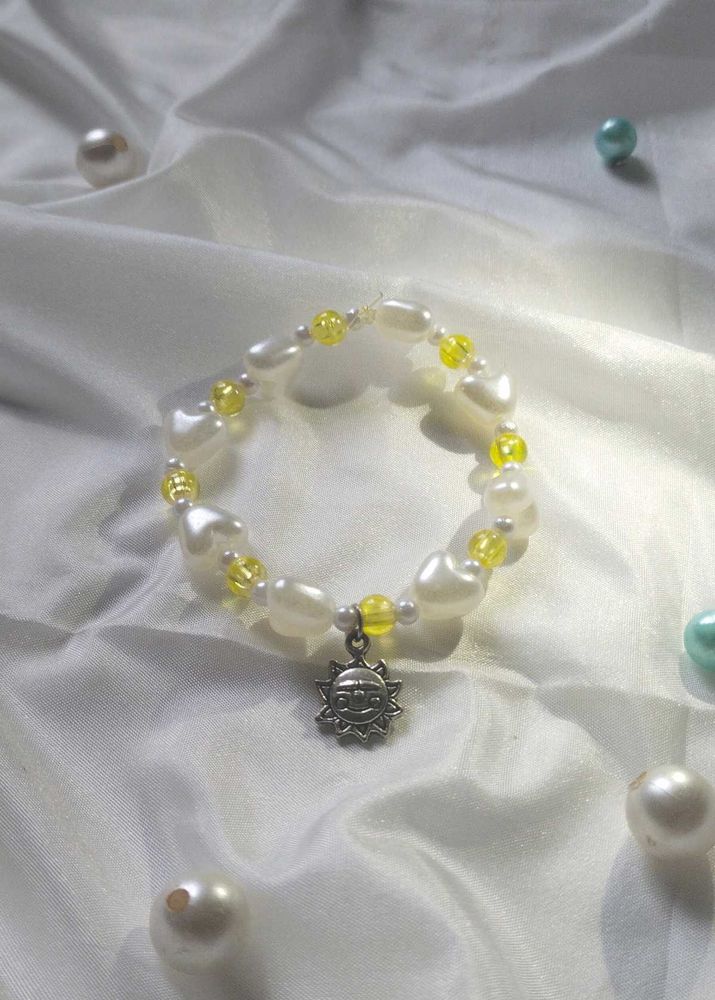 Handcrafted Yellow And White Bracelet With Charm