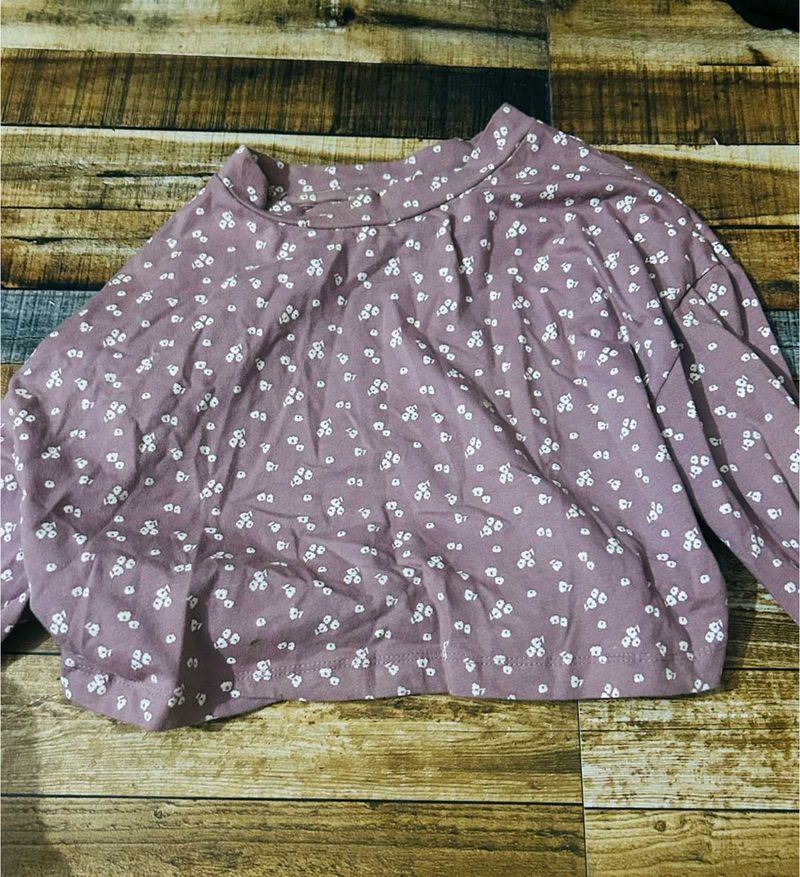 light pink long-sleeved top with a white floral