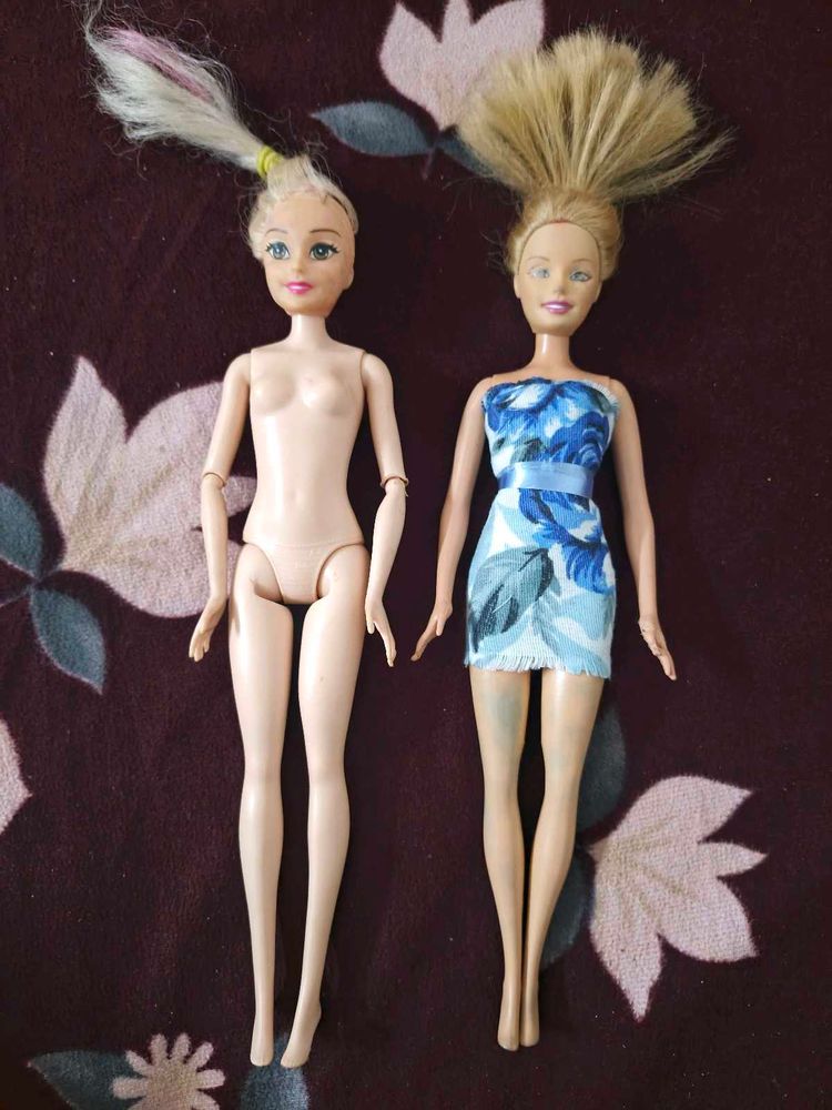 Two used barbie dolls