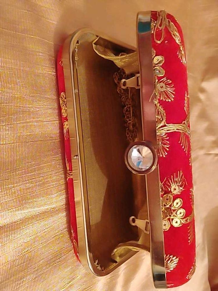 red clutch with zari work