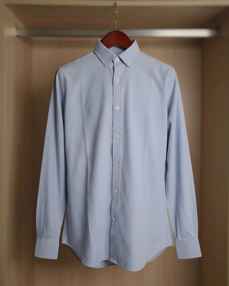 Long-sleeve polo shirt with a button-down collar.